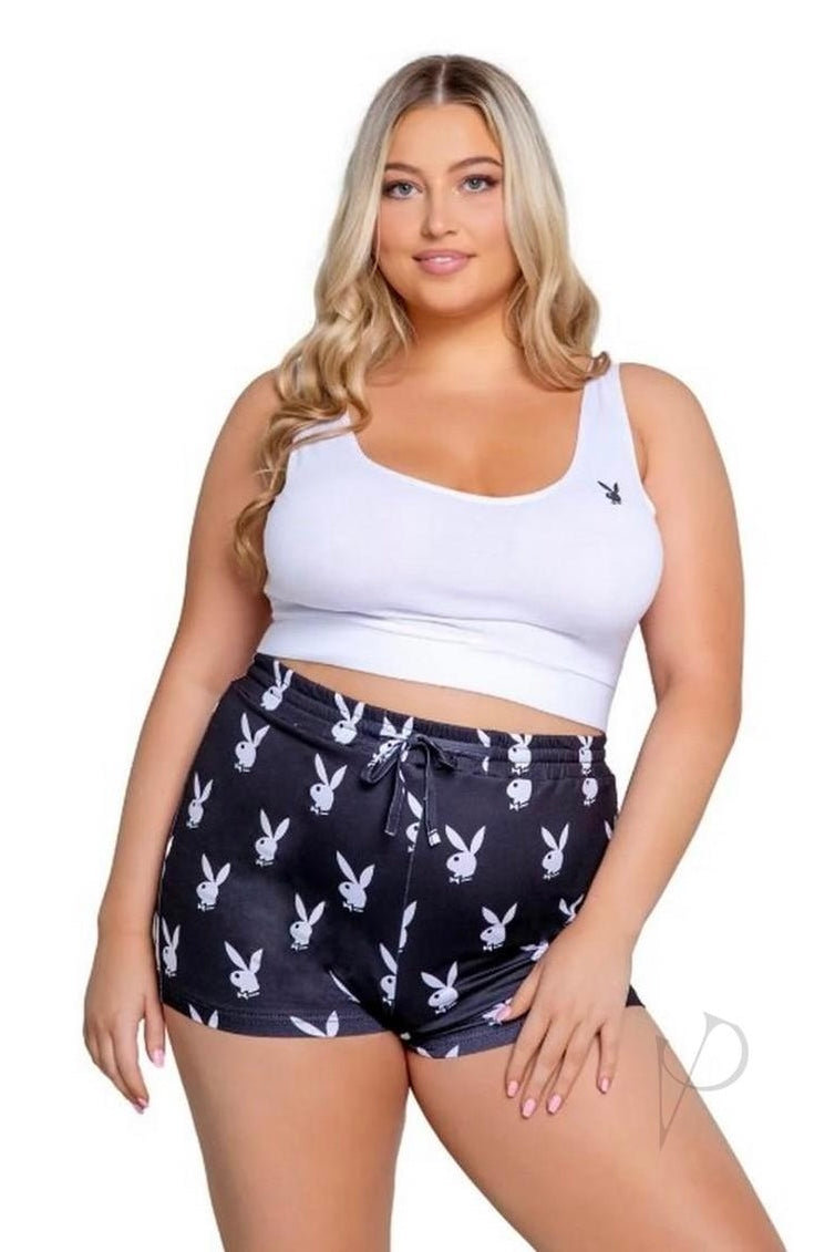 Woman wearing a white tank top and black shorts with bunny print on a white background