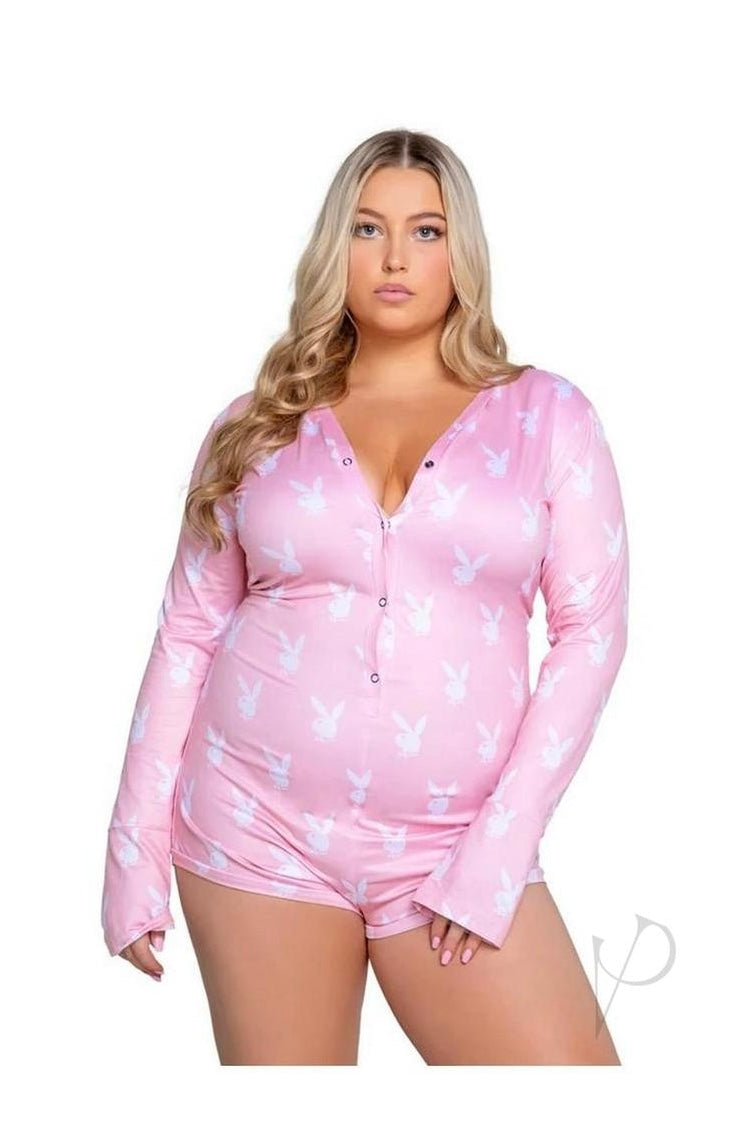 Woman wearing a pink long-sleeve top and shorts with butterfly pattern on a white background