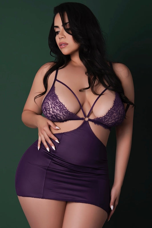 Woman wearing a purple lace lingerie set against a dark background