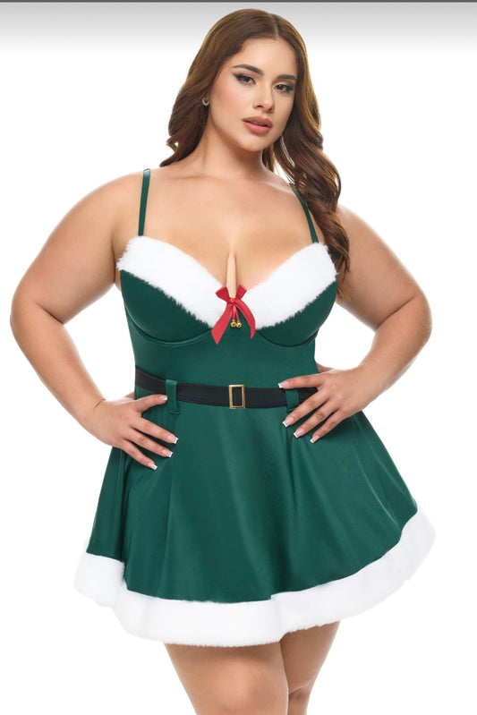 Woman wearing a green dress with white trim and red accents on a white background