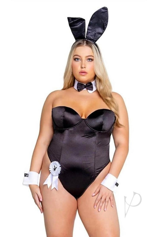Woman wearing a black satin bunny costume with ears, bow tie, and gloves on a white background.
