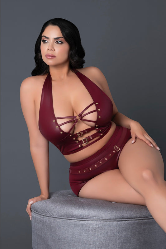Woman wearing a burgundy lingerie set on a gray background