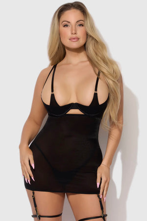 Woman wearing a black slip dress against a white background