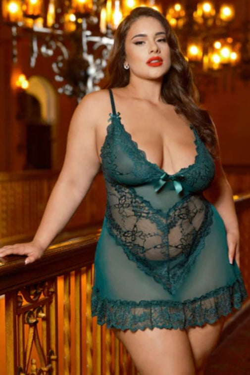 Woman wearing a teal lace lingerie set in an elegant interior setting.