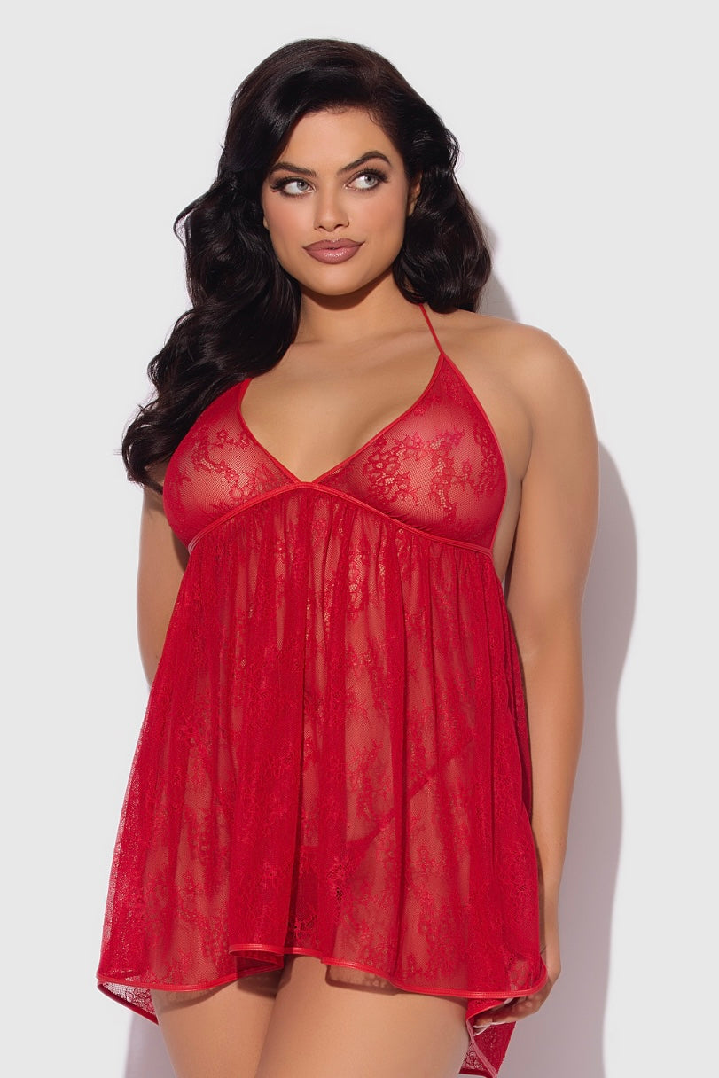 Woman wearing a red lace babydoll dress against a white background