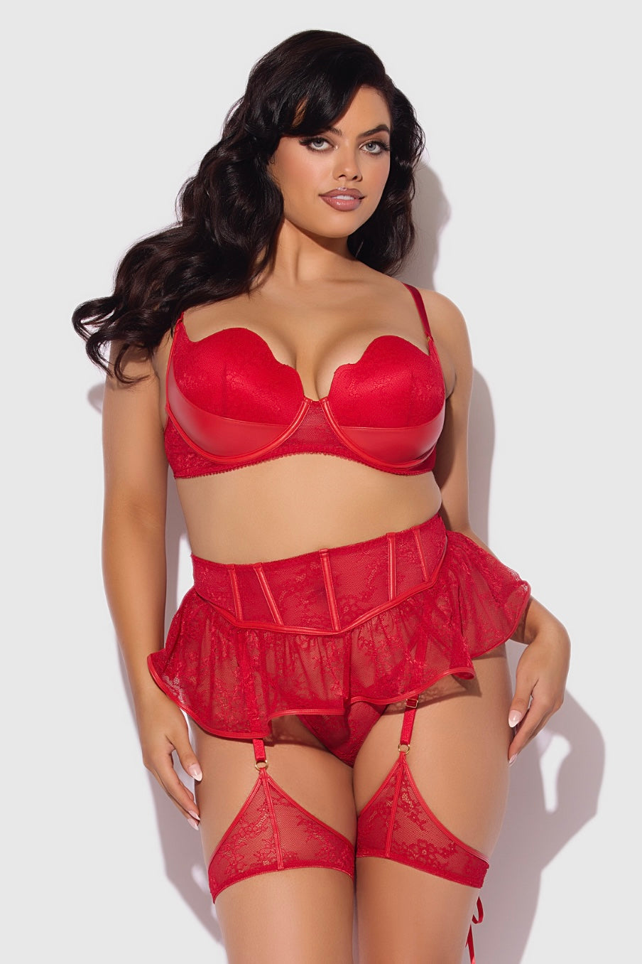 Woman wearing a red lingerie set against a white background